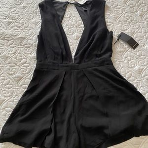 Low cut front, open back romper.
